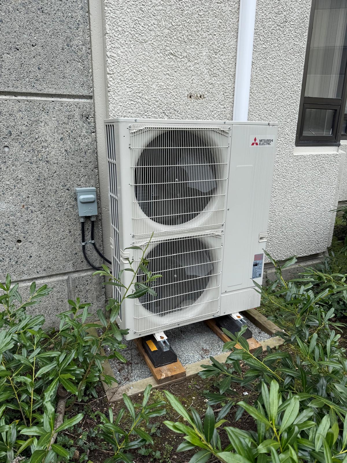 Residential heat pump installed outside a home